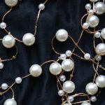 Gold,Threads,With,Pearls,On,Black,Silk,,Beautiful,Luxury,Background