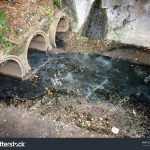 stock-photo-toxic-water-running-from-sewers-in-dirty-underground-sewer-for-dredging-drain-tunnel-cleaning-513890194