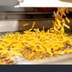 stock-photo-pasta-factory-close-up-of-raw-pasta-on-machines-and-conveyor-pasta-production-equipment-modern-2519169577